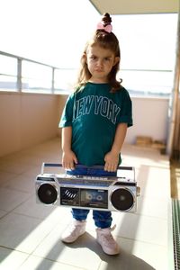 Portrait of a girl with a radio boombox ghettoblaster 