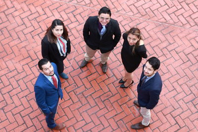 High angle view of friends standing on tiled floor