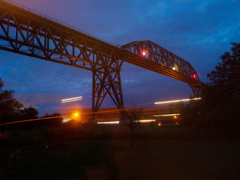 Low angle view of bridge against sky at night