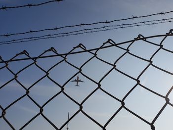 Low angle view of chainlink fence against clear sky