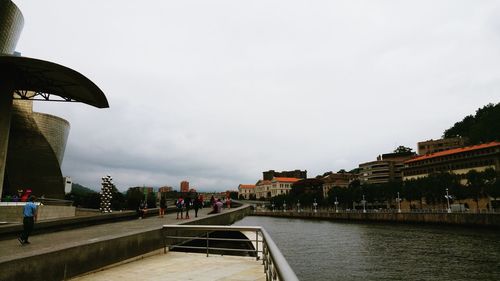 City by river against sky