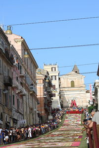 Group of people in city against buildings