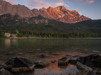 Scenic view of lake by mountains against sky