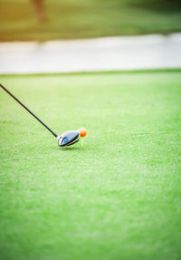 Golf ball teeing off on field