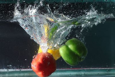 Close-up of bell peppers splashing in water