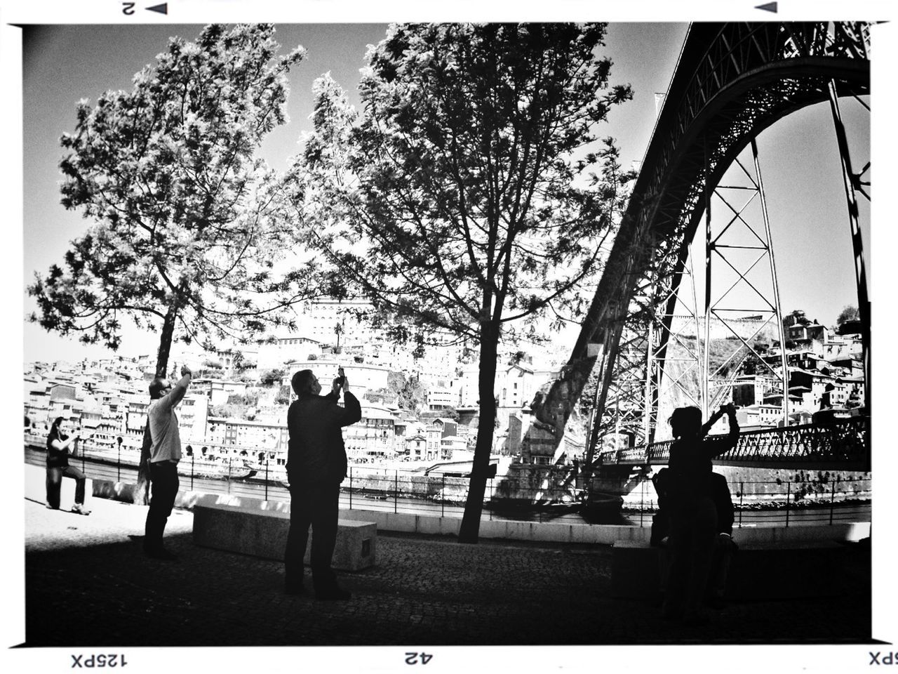 transfer print, auto post production filter, men, lifestyles, leisure activity, built structure, architecture, full length, water, person, bridge - man made structure, tree, river, railing, standing, silhouette, rear view, connection