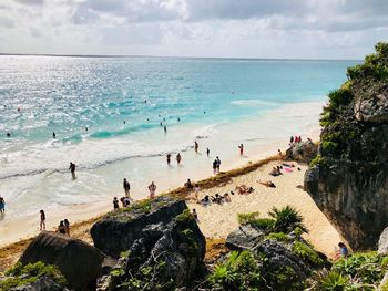 People on beach against sky