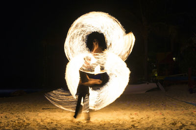 Full length of man with illuminated fire hydrant at night