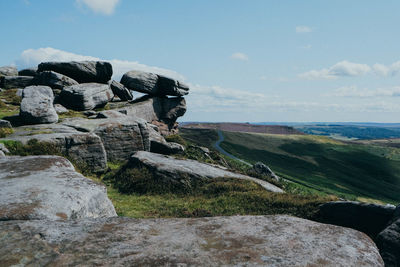 Rock formations on landscape against sky