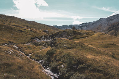 Scenic view of landscape and mountains against sky