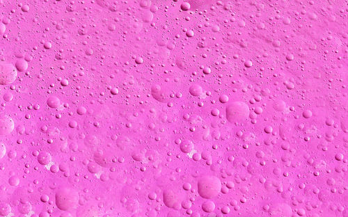 Full frame shot of water drops on pink wall