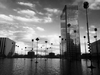 Buildings against cloudy sky