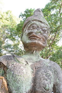 Low angle view of statue against trees