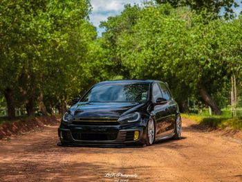 Car on dirt road in city