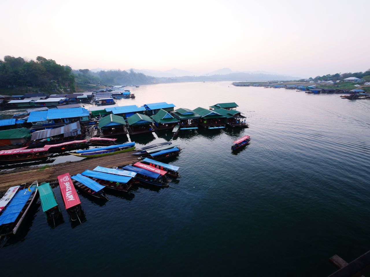 reflection, sky, outdoors, in a row, transportation, multi colored, scenics, large group of objects, no people, tranquility, nautical vessel, beauty in nature, nature, water, day, sea, pedal boat