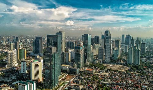 High angle view of modern buildings in city against sky