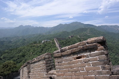 View of ruins of mountain against cloudy sky