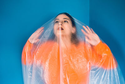 Portrait of woman against blue background