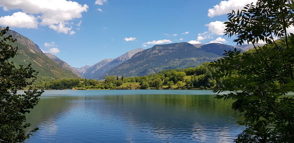 Scenic view of lake and mountains against sky