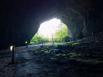 Road in tunnel seen through cave