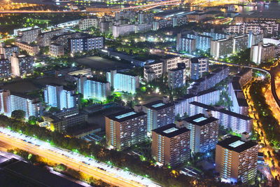 High angle view of city lit up at night