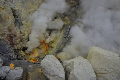 Active volcano crater ijen emits smoke