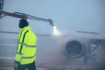 Rear view of man standing against sky