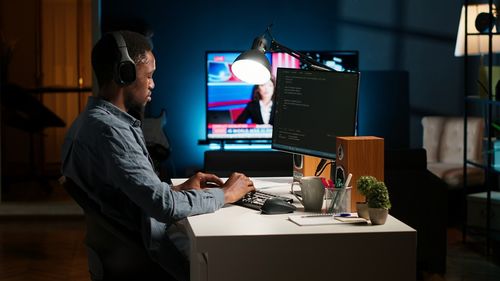 Side view of man using laptop at office