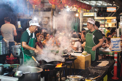 People at market stall in city