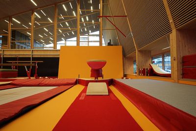 Empty chairs and tables in illuminated room