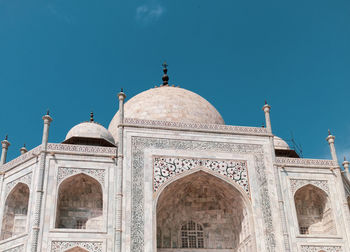 Low angle view of taj mahal against blue sky