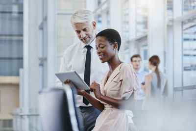 Businessman and businesswoman with digital tablet