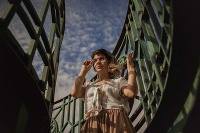 Low angle view of woman standing against wall