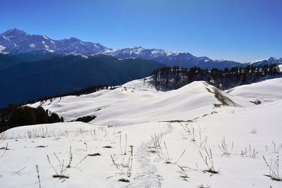 Scenic view of snow covered mountains against sky