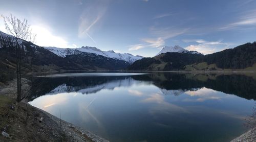 Scenic view of lake and mountains against sky