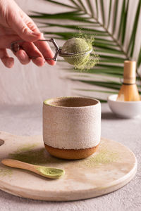 Woman preparing green matcha tea