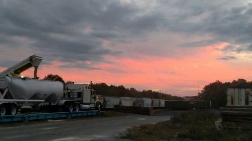 Road against cloudy sky at sunset