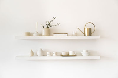 Various bottles on shelf against white background