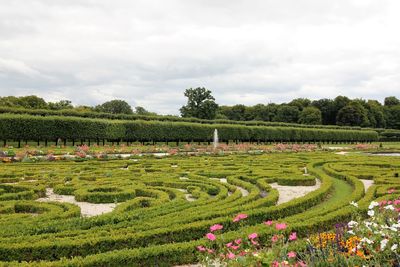 Scenic view of formal garden on field against sky