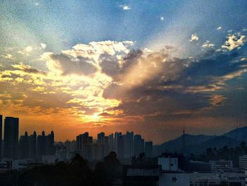 Silhouette buildings against sky during sunset