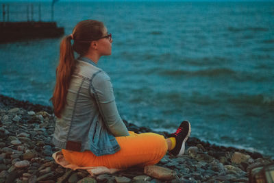 Young woman sitting on beach