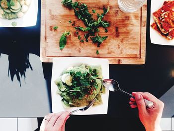 High angle view of hand holding food on table