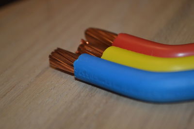 Close-up of multi colored wires on table