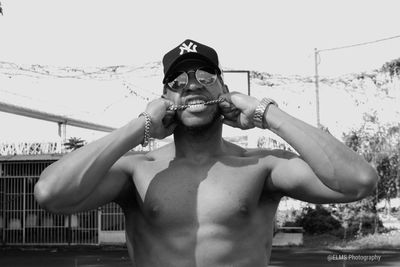 Portrait of young man standing in swimming pool