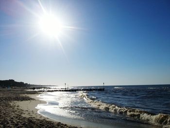 Scenic view of sea against clear sky during sunny day