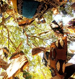 Various bags hanging on tree at market