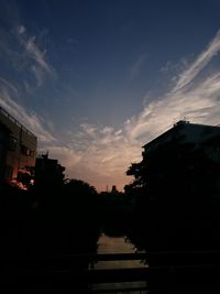 View of built structures against sunset