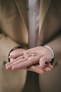 Midsection of bride holding wedding rings