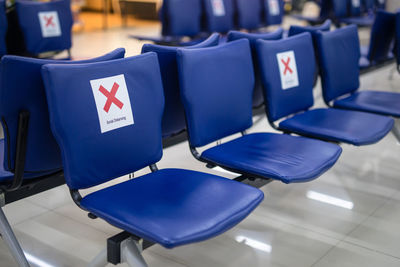 Social distancing, symbol sticker on chair in international airport