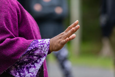 Close-up of woman hand holding purple outdoors